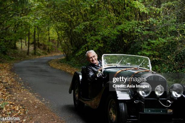 senior man driving in antique car - country road stock pictures, royalty-free photos & images