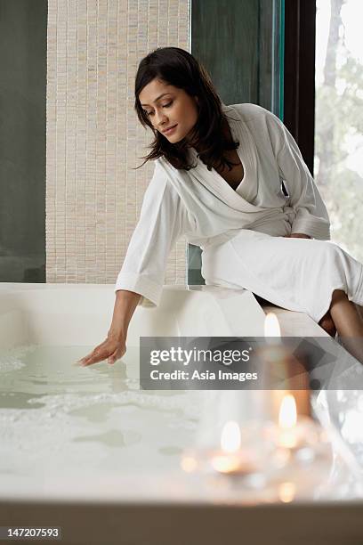 woman getting ready for the bath - domestic bathroom stock pictures, royalty-free photos & images