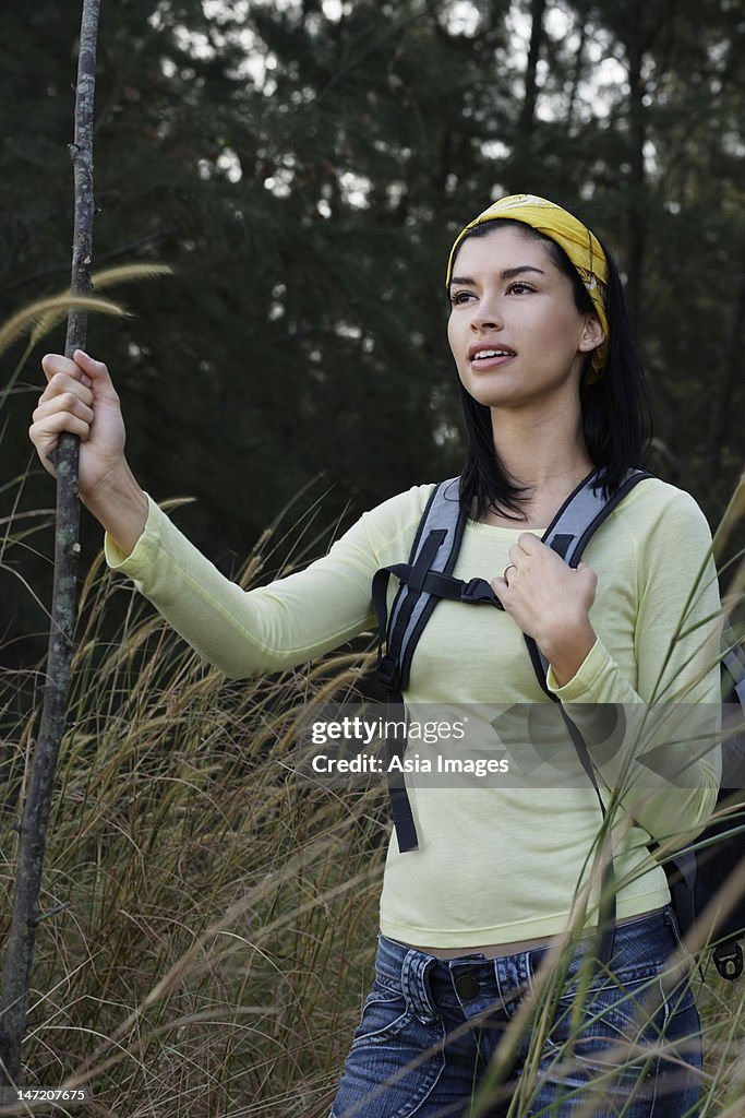 Woman hiking in tall grass