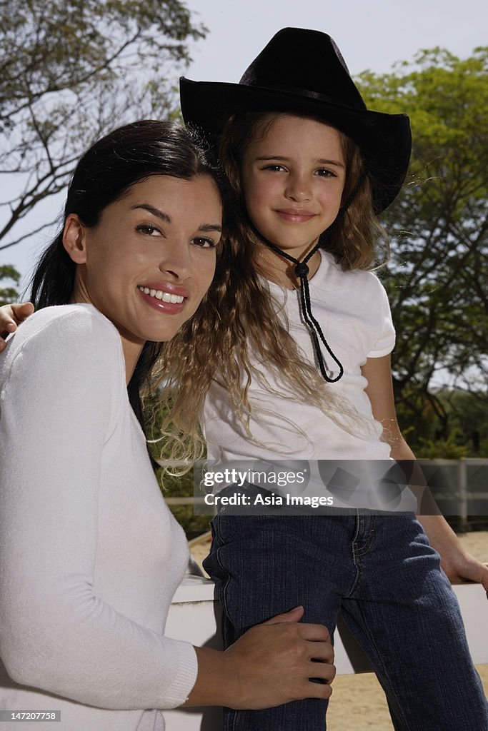 Woman and child, girl wearing cowboy hat