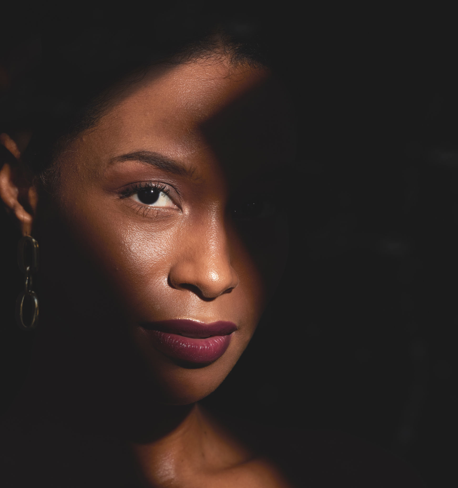 Shadow, black woman and portrait of beauty, makeup and creative spotlight with cosmetics, skincare and glow. Face, model and dark mystery background for facial aesthetic, fantasy and luxury fashion Shadow, black woman and portrait of beauty, makeup and creative spotlight with cosmetics, skincare and glow. Face, model and dark mystery background for facial aesthetic, fantasy and luxury fashion