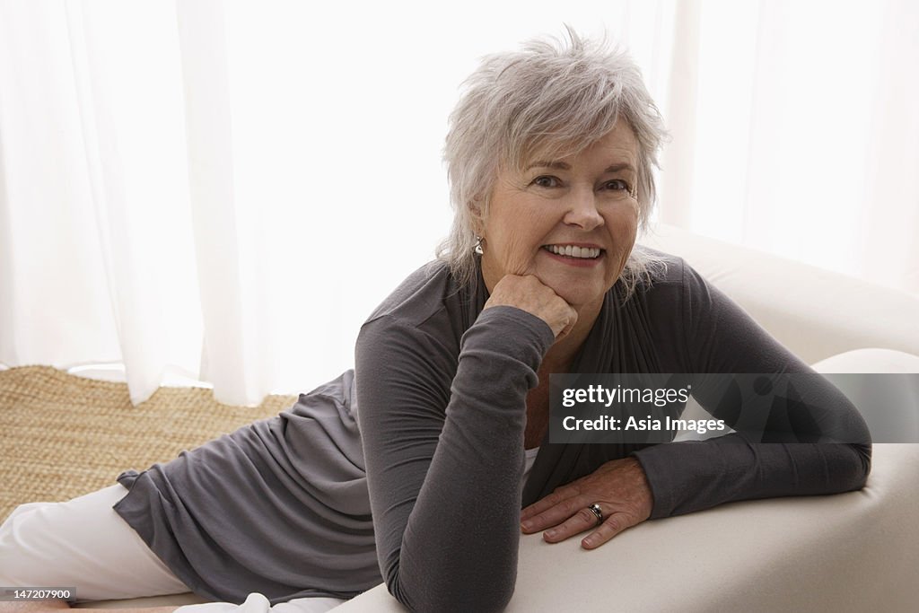 Older woman relaxing at home and smiling.