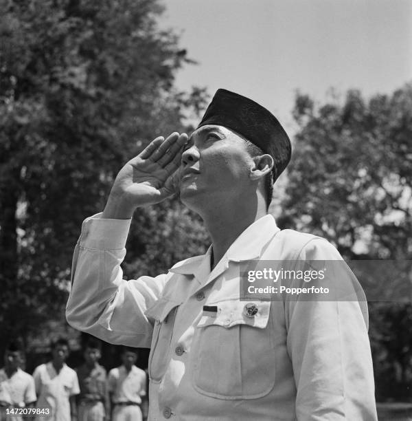Indonesian statesman Sukarno , recently appointed President of Indonesia, salutes as the national flag of Indonesia is raised, following Indonesia's...