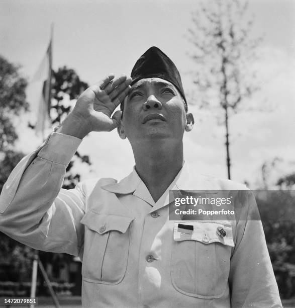 Indonesian statesman Sukarno , recently appointed President of Indonesia, salutes as the national flag of Indonesia is raised, following Indonesia's...