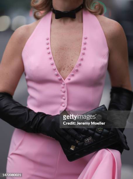 Olga Ferrara seen wearing black leather bow necklace, Maxara pink suit gilet / vest, matching Maxara pink suit pants, Chanel black leather studded...