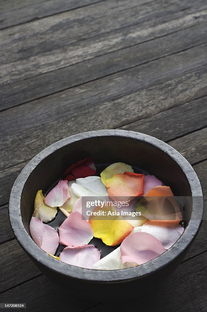 Petals floating in wooden bowl