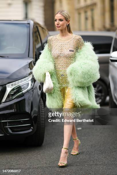 Leonie Hanne wears silver and rhinestones star earrings, a pale green with embroidered white rhinestones and green sequined checkered pattern long...