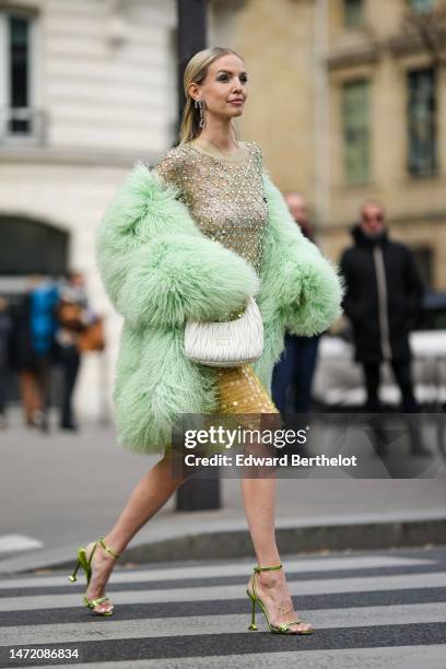 Leonie Hanne wears silver and rhinestones star earrings, a pale green with embroidered white rhinestones and green sequined checkered pattern long...