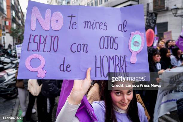 Young woman with a banner during a demonstration called by the Student Union and 'Libres y Combativas', for 8M, International Women's Day, on March 8...