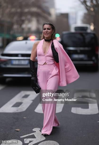 Olga Ferrara seen wearing Katandclerese black headpiece, Pharaoun Cocktail Rings colorful diamond earrings, black leather bow necklace, Maxara pink...