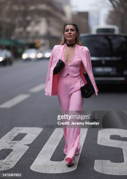 Olga Ferrara seen wearing Katandclerese black headpiece, Pharaoun Cocktail Rings colorful diamond earrings, black leather bow necklace, Maxara pink...