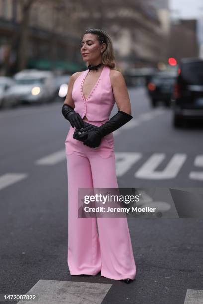 Olga Ferrara seen wearing Katandclerese black headpiece, Pharaoun Cocktail Rings colorful diamond earrings, black leather bow necklace, Maxara pink...