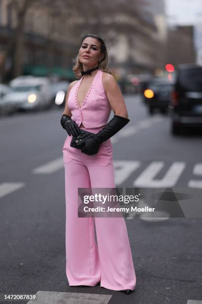 Olga Ferrara seen wearing Katandclerese black headpiece, Pharaoun Cocktail Rings colorful diamond earrings, black leather bow necklace, Maxara pink...