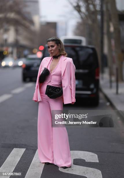 Olga Ferrara seen wearing Katandclerese black headpiece, Pharaoun Cocktail Rings colorful diamond earrings, black leather bow necklace, Maxara pink...