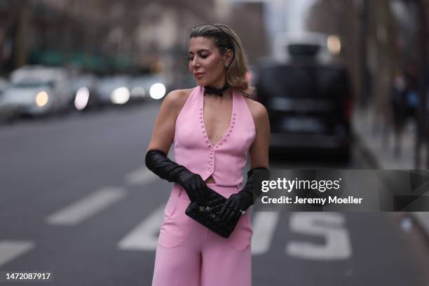 Olga Ferrara seen wearing Katandclerese black headpiece, Pharaoun Cocktail Rings colorful diamond earrings, black leather bow necklace, Maxara pink...