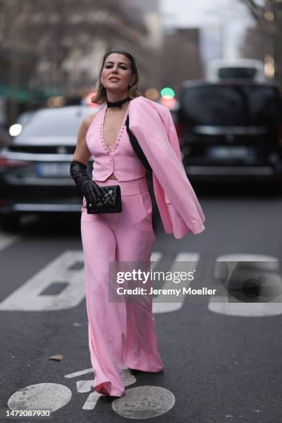 Olga Ferrara seen wearing Katandclerese black headpiece, Pharaoun Cocktail Rings colorful diamond earrings, black leather bow necklace, Maxara pink...