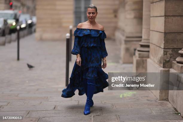 Olga Ferrara seen wearing Ungaro royal blue flower print pattern off-shoulder pleated long dress, Amato gold jewerly, Valentina Rangoni blue metallic...