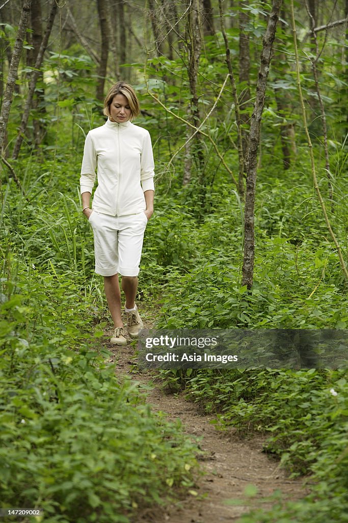 Young woman walking in woods