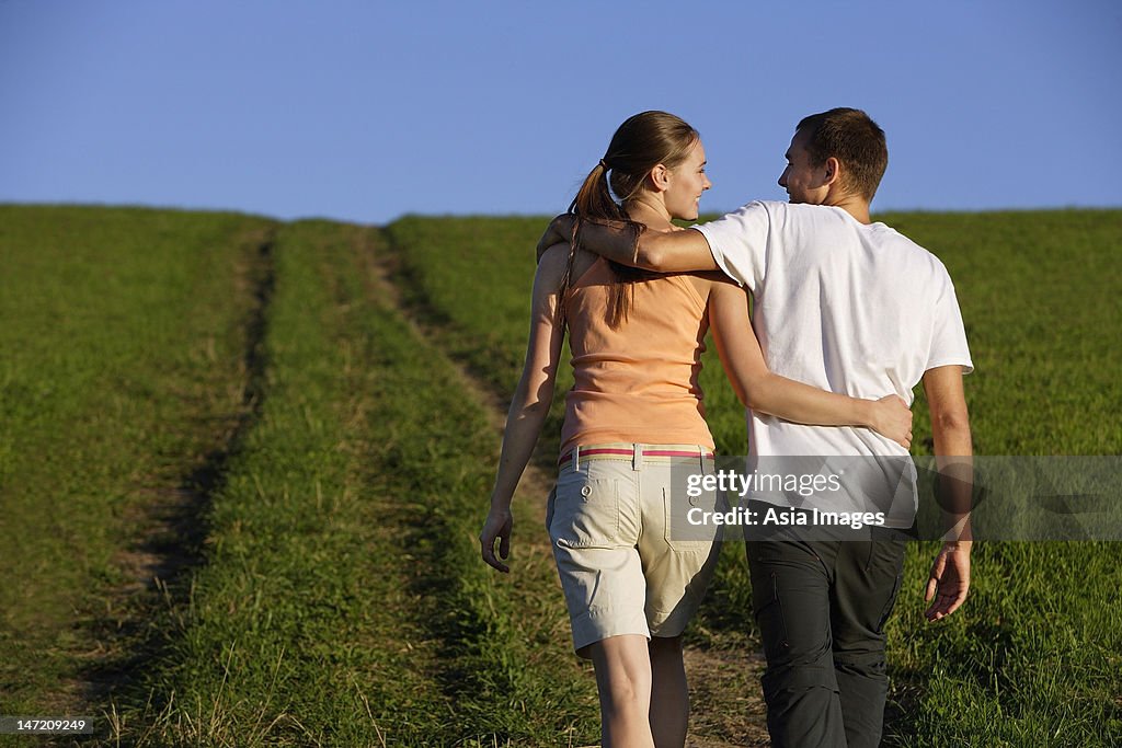 Young couple taking walk up hillside