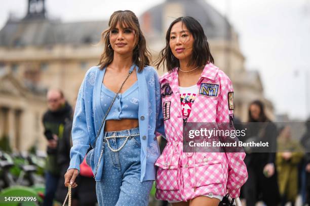 Camila Coelho gold earrings, a pale blue with cut-out white pattern buttoned cropped top from Chanel, a matching pale blue with cut-out white pattern...