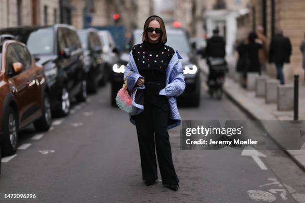 Katya Bychkova seen wearing Prada Symbole black sunglasses, Acne Studios shiny light blue / lilac quilted jacket, MSGM black hoodie with colorful...