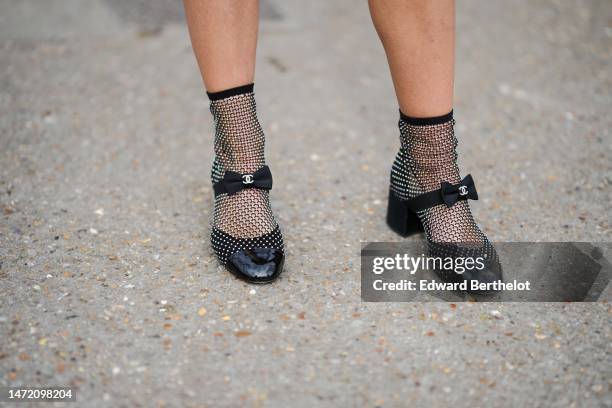 Sophia Roe wears black mesh / fishnet embroidered rhinestones block heels socks ankle boots from Chanel , outside Chanel, during Paris Fashion Week -...