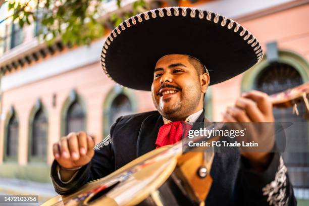 traditional mariachi guitarist playing at the historic district - mariachi stock pictures, royalty-free photos & images