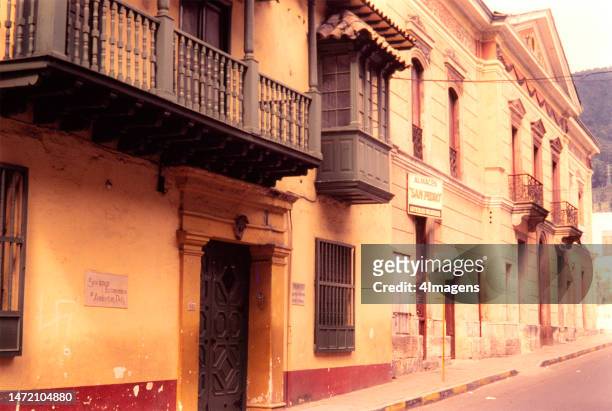View of a street in Bogota, Colombia, in the 80s, with buildings in colonial architecture style.