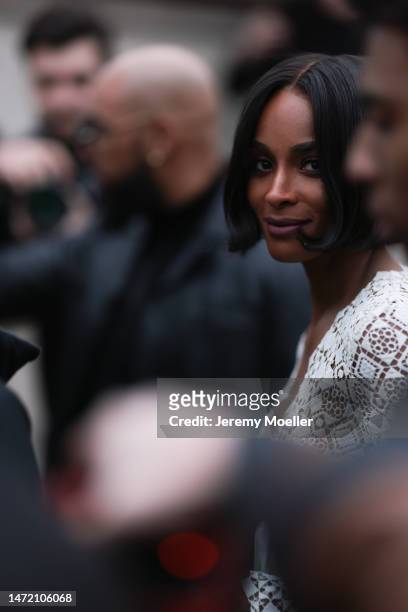 Ciara wears a white Elie Saab dress with lace fabric, outside Elie Saab show, during Paris Fashion Week on March 04, 2023 in Paris, France.