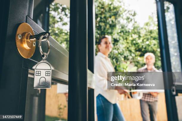 couple celebrating moving day, mortgage, and relocation concept. - buying a home stock-fotos und bilder