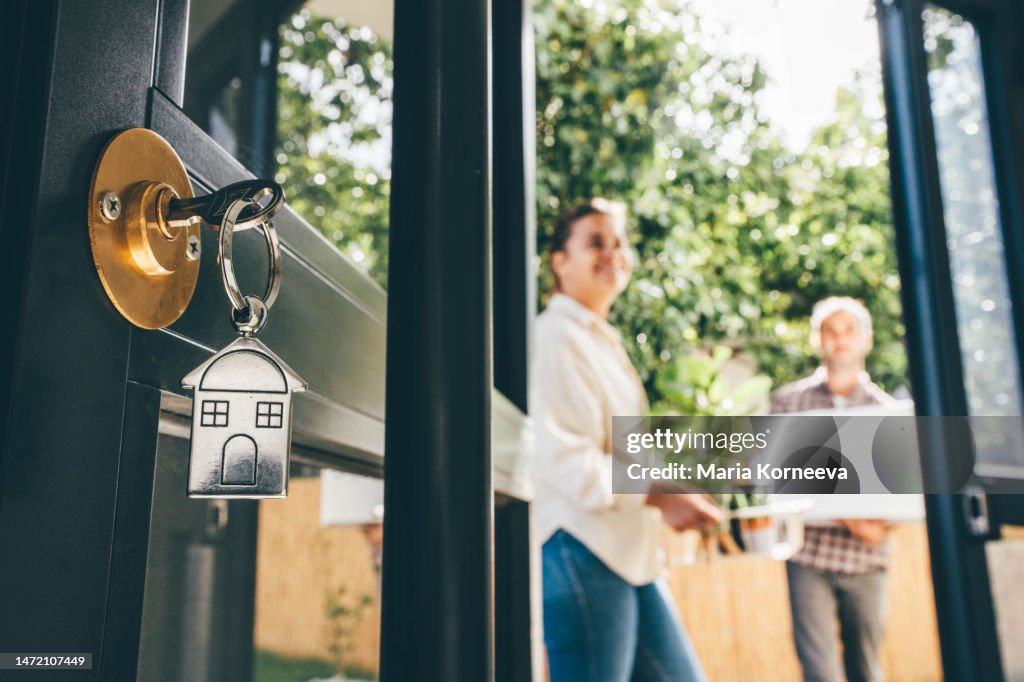 Couple celebrating moving day, mortgage, and relocation concept.