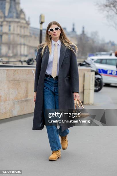 Veronika Heilbrunner is seen wearing grey coat, bag with logo print, laced beige hiking boots outside Louis Vuitton during the Paris Fashion Week -...