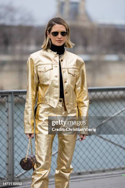Helena Bordon is seen wearing golden jacket, pants, black turtleneck, sunglasses, bag with logo print outside Louis Vuitton during the Paris Fashion...