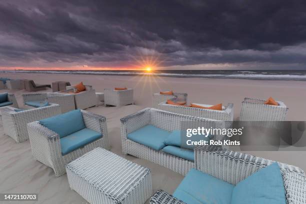 dark clouds at sunset on kijkduin beach the hague at the end of summer - scheveningen bildbanksfoton och bilder