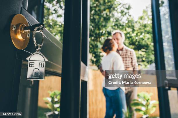 couple celebrating moving day, mortgage, and relocation concept. - tenant stock pictures, royalty-free photos & images