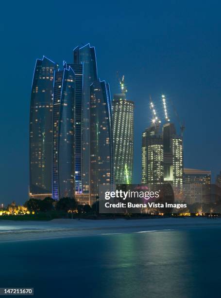 abu dhabi. futuristic skyscrapers facing the beach - abu dhabi night stock pictures, royalty-free photos & images