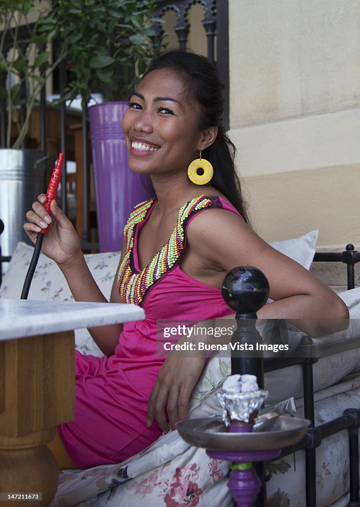 Middle eastern woman smoking traditional Shisha