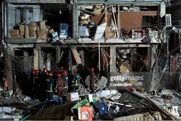 Firefighters and emergency teams work amid debris after an explosion inside Siddique Bazar in Old Dhaka on March 7, 2023 in Dhaka, Bangladesh. An...