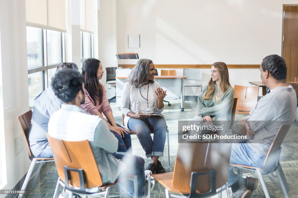 Mental Health Therapist Helps To Facilitate A Group Discussion High-Res