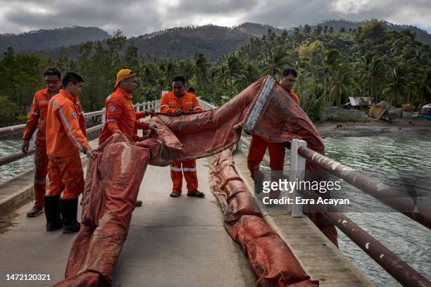 Coast guard personnel deploy a boom to contain the oil spill from the sunken MT Princess Empress on March 08, 2023 in Pola, Oriental Mindoro,...