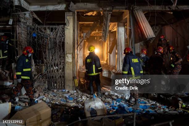 Firefighters and emergency teams work amid debris after an explosion inside Siddique Bazar in Old Dhaka on March 7, 2023 in Dhaka, Bangladesh. An...