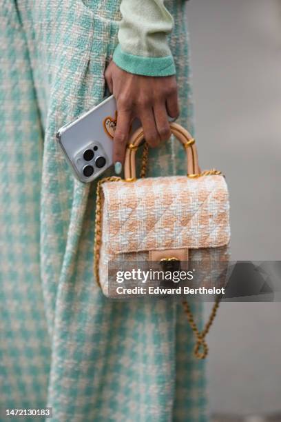 Yoyo Cao wears white latte and pale green tweed pattern wide legs pants from Chanel, matching white latte and pale green print pattern mittens, a...