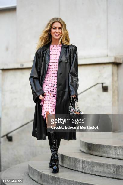 Emili Sindlev wears a pink embroidered coins short sleeves / short dress from Paco Rabanne, a matching silver coins handbag from Paco Rabanne, black...