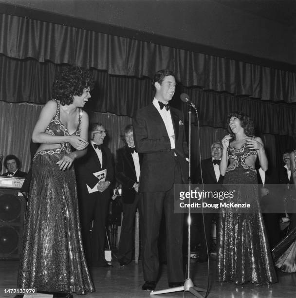 Prince Charles takes the stage with American soul vocal group, The Three Degrees, during a charity fundraising event for the Prince's Trust at the...
