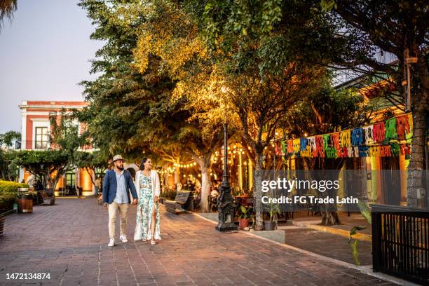 married couple walking along the historic district - mazatlan mexico stock pictures, royalty-free photos & images