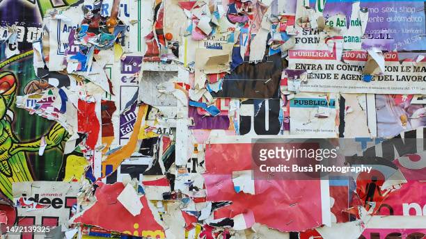 scratched layers of posters and placards on wall - poster wall stockfoto's en -beelden