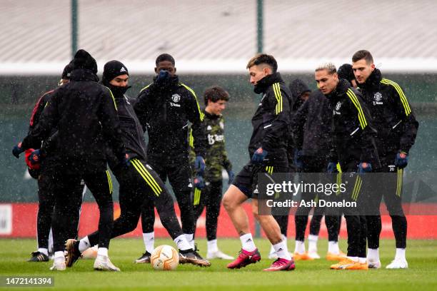 Casemiro, Lisandro Martinez and team mates of Manchester United train during a training session ahead of their UEFA Europa League round of 16 leg one...