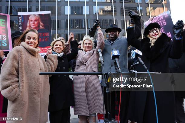 Attorney Ben Crump raises his hand with former music executive Dorothy Carvello advocate Gretchen Carlson and others in announcing a sexual assault...