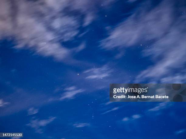 full frame of the night sky with stars and high clouds. - cloudy to clear sky stock pictures, royalty-free photos & images