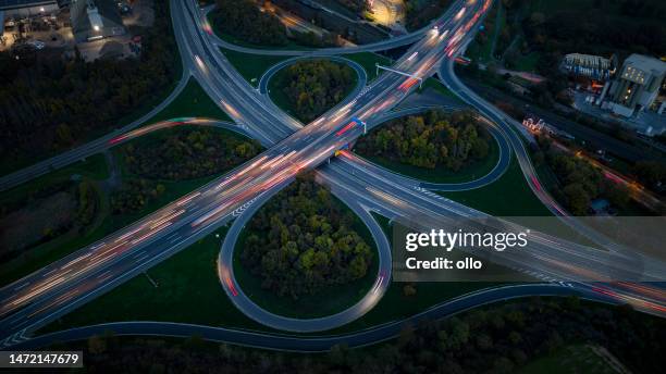 highway interchange and industrial district at dusk - aerial view - car top view stock pictures, royalty-free photos & images